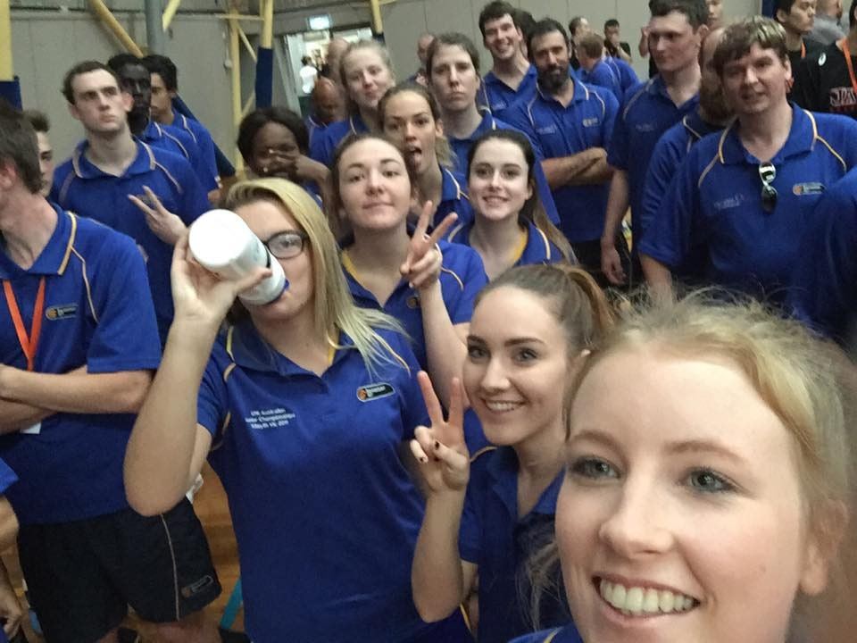 The ACT U20 women's team pack into a group selfie in matching blue team polos, several making peace signs.