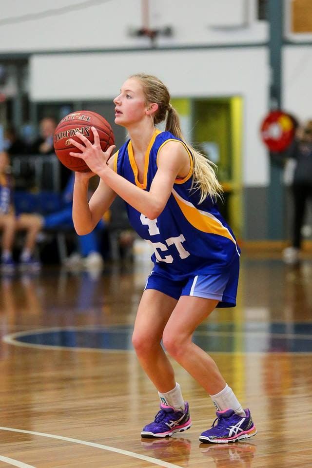 A player in an ACT representative jersey lines up a free throw on an indoor court.