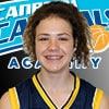Head-and-shoulders portrait of a smiling teenage player in a blue and gold Capitals Academy jersey.