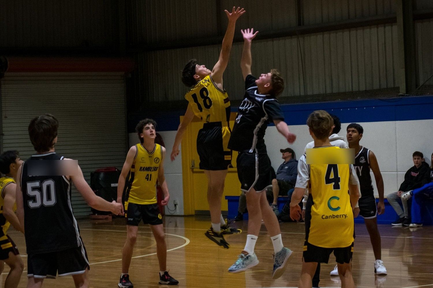 A tip-off at the start of a tournament game, the ball at its highest point